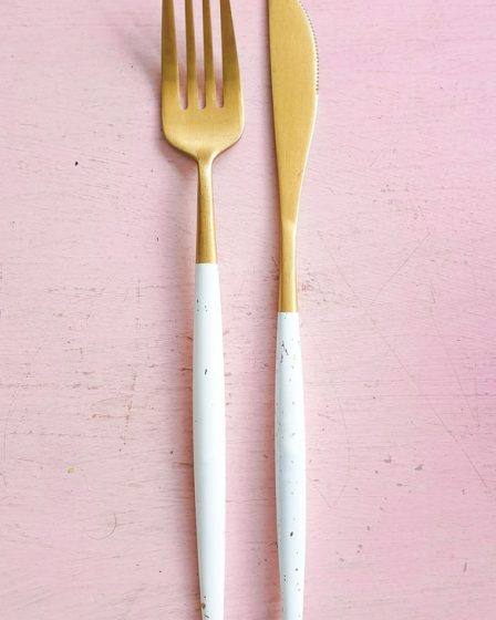 pair of white-and-brass fork and breadknife