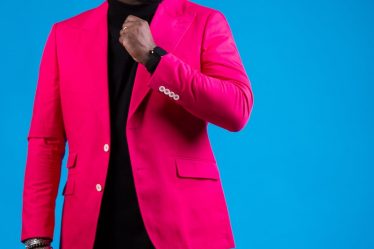 man in pink suit wearing sunglasses