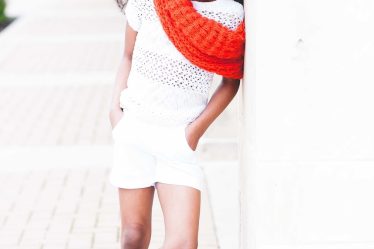 smiling girl in white shirt and shorts wearing red scarf during daytime