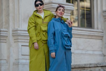 two women wearing coat standing on staies