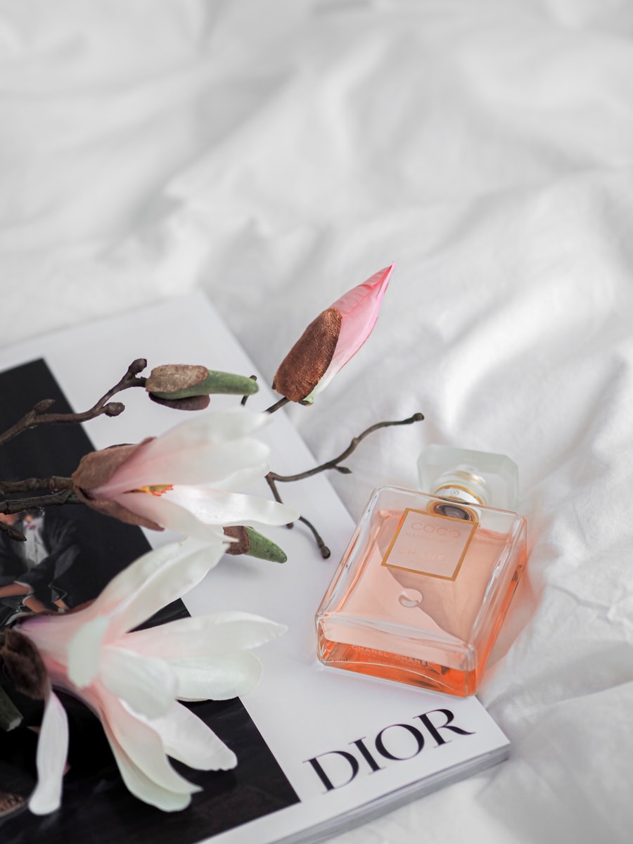 pink perfume bottle on white textile