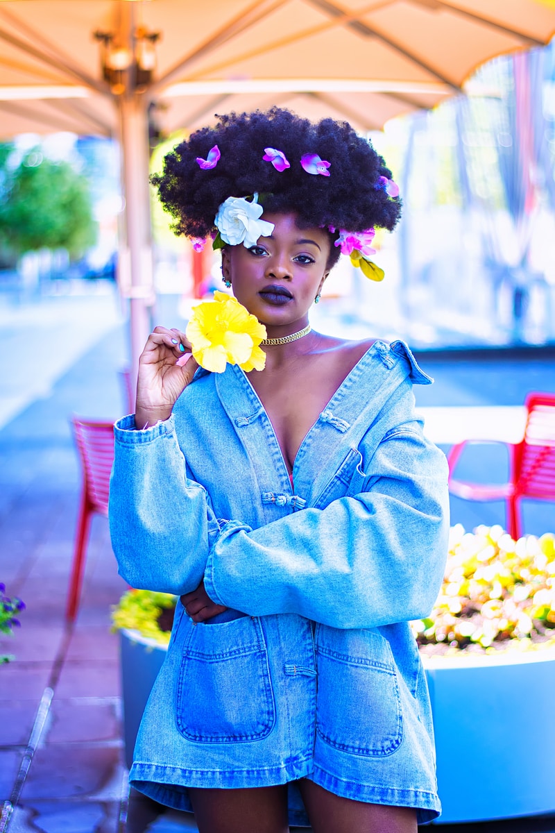 woman wearing blue denim jacket with flowers on hair
