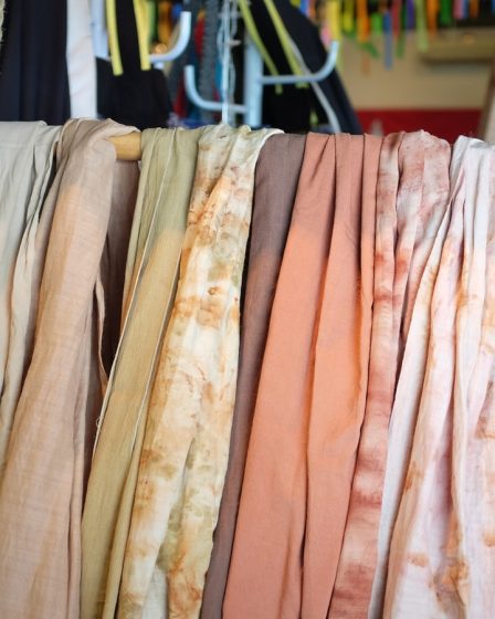 assorted scarves on brown wooden rack