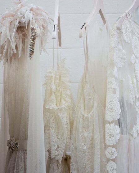 six women's white dresses hanging on hangers