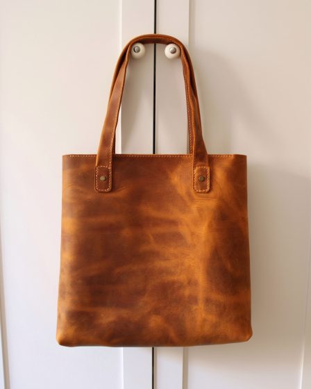 brown leather handbag on white table